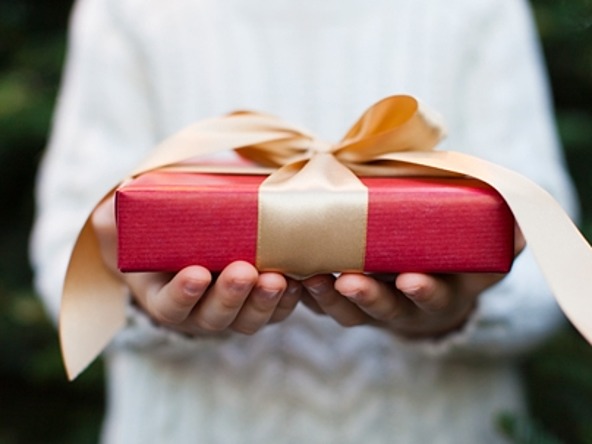 person holding ribbon-wrapped gift